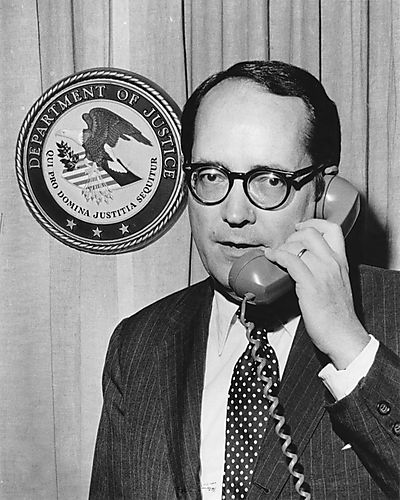 On telephone with Department of Justice seal in background