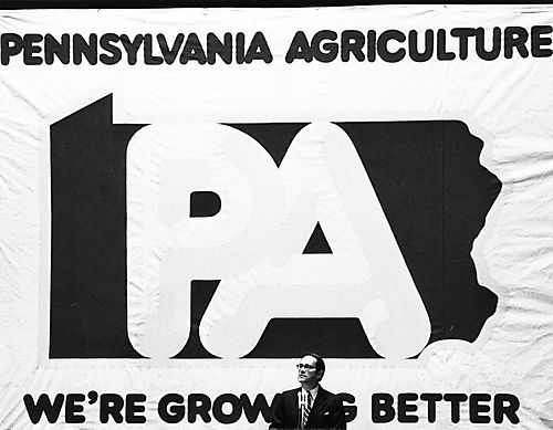 Thornburgh speaking in front of large "Pennsylvania Agriculture / We're Growing Better" sign