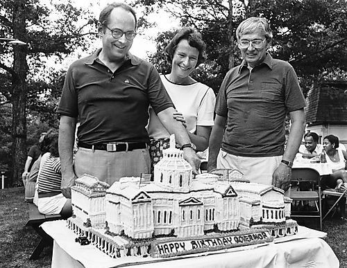Governor and Ginny Thornburgh and Secretary Baran with Governor's birthday cake, in the shape of the capitol building