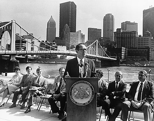 Thornburgh speaking at Renaissance III event beside Allegheny River with Pittsburgh view in background