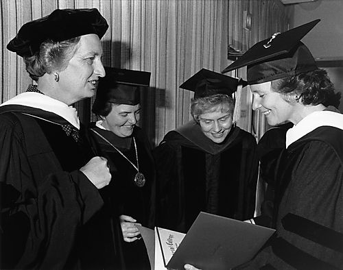 Ginny Thornburgh looking at honorary degree awarded her by Cabrini College