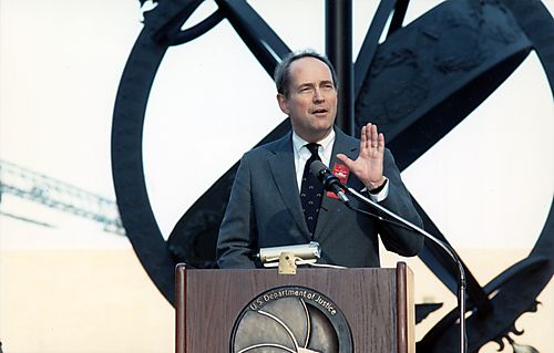 Thornburgh speaking at the Drug Enforcement Administration (DEA) Headquarters Dedication Ceremony in front of bold sculpture
