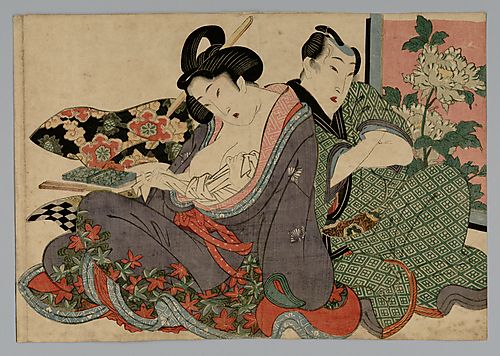A young couple seated by a screen