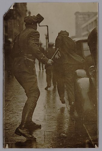 A Communist Rioter Getting Chased by a Police Officer