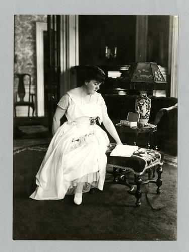 Mary Roberts Rinehart portrait in white, reading