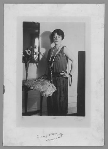 Mary Roberts Rinehart portrait with bead necklace and fan