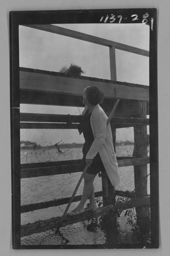 Mary Roberts Rinehart on pier with net