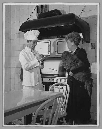 Mary Roberts Rinehart in kitchen with chef