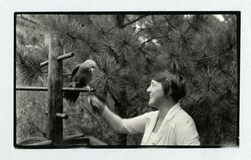 Mary Roberts Rinehart outdoors with parrot
