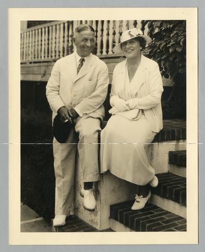 Mary Roberts Rinehart seated on steps with unidentified man