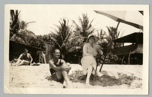 Mary Roberts Rinehart on beach with unidentified man