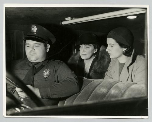 Mary Roberts Rinehart in car with policeman and unidentified woman