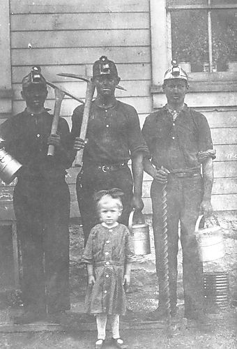 Three Miners with a Child